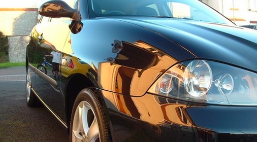 the front side of a black car