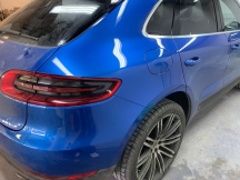 Shiny blue car rear corner