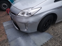 Silver car during the repair process with damage to front bumper