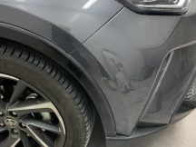 Close up of grey metallic car front bumper and headlight