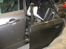 Metallic grey car with rear door removed