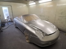 Car in spray booth after being sprayed silver
