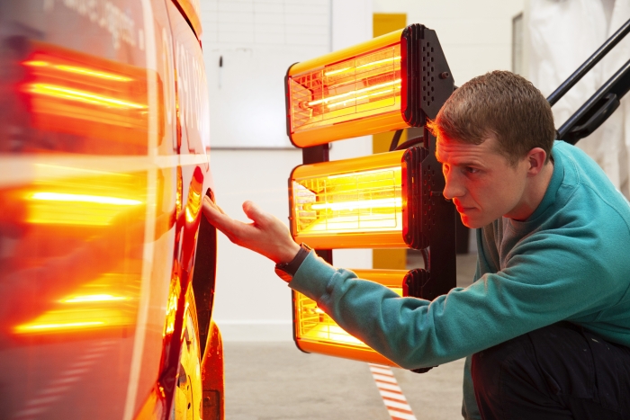 ChipsAway specialist curing paintwork after damage repair with heat lamp