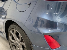 Blue grey car bumper and wheel