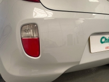 White car shiny bumper close up