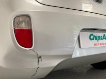 White car with cracked bumper damage