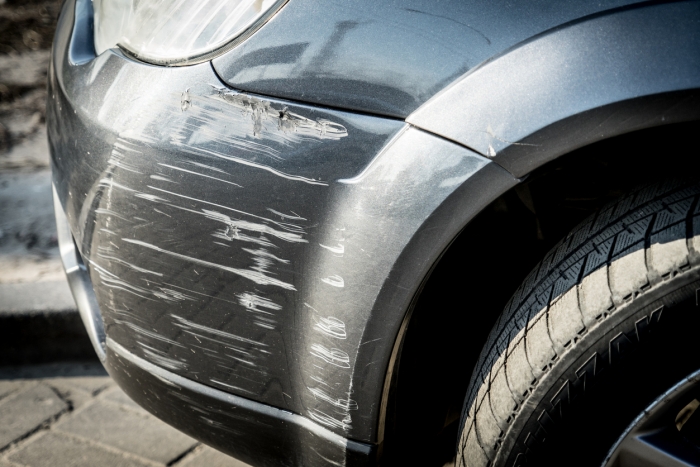 car bumper scratched, dented and cracked