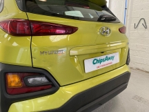 Yellow car with dent on rear door