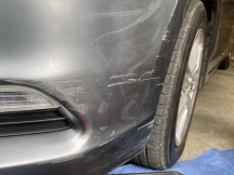 Grey car with scratch on front bumper